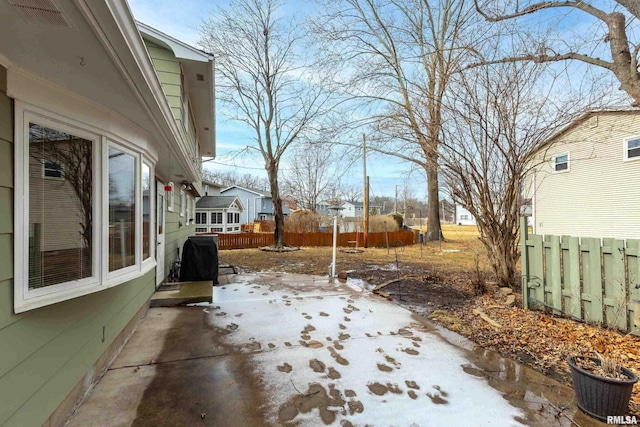 view of yard featuring a patio area, fence, and visible vents