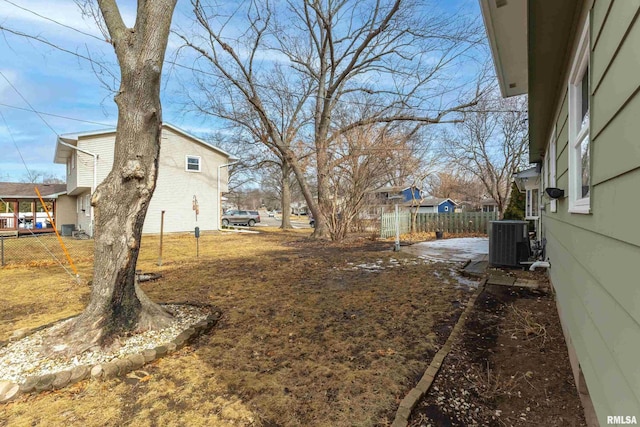 view of yard with fence and central AC unit