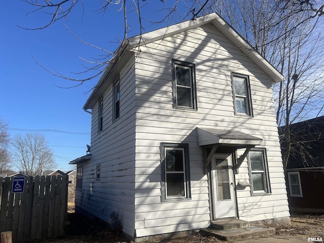 view of front facade featuring fence