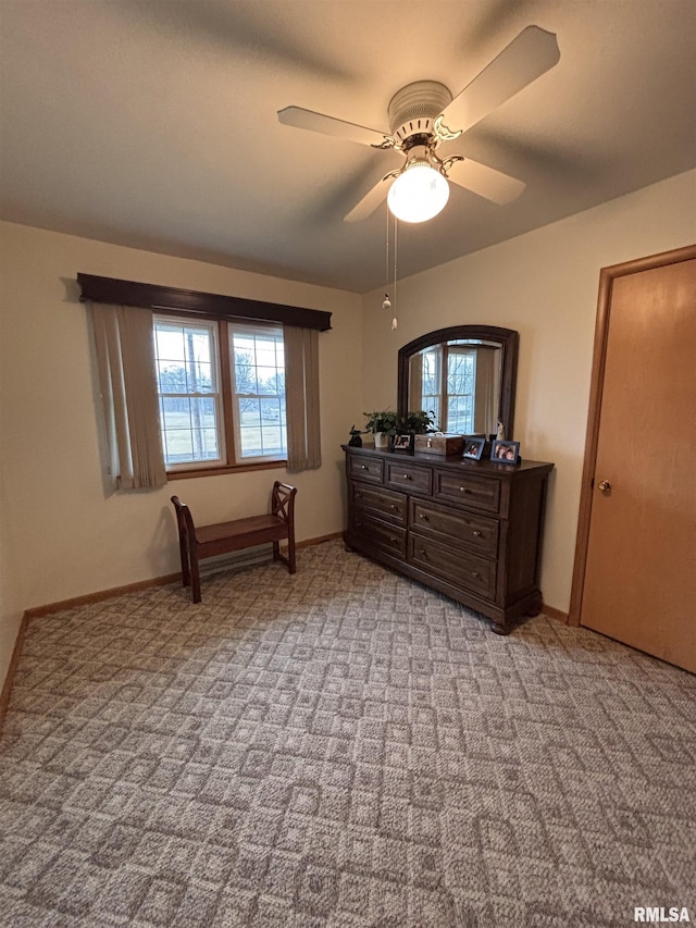 bedroom with a ceiling fan, light carpet, and baseboards