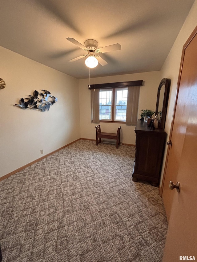 unfurnished bedroom featuring carpet, a ceiling fan, and baseboards