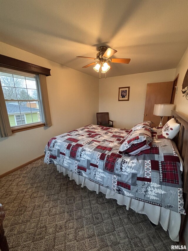 carpeted bedroom with baseboards and a ceiling fan