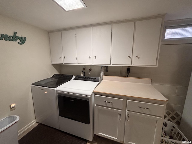 laundry area with cabinet space, washer and clothes dryer, and baseboards