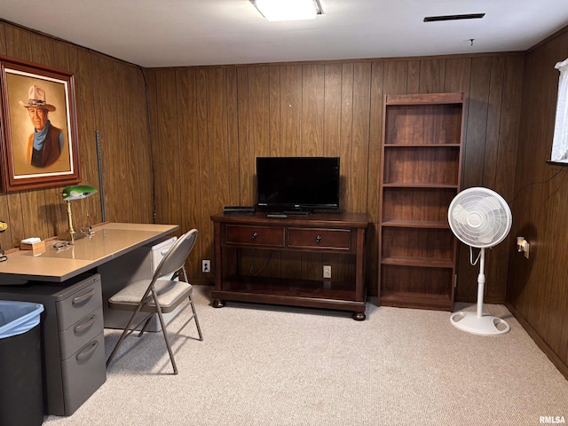 office area with light carpet and wood walls