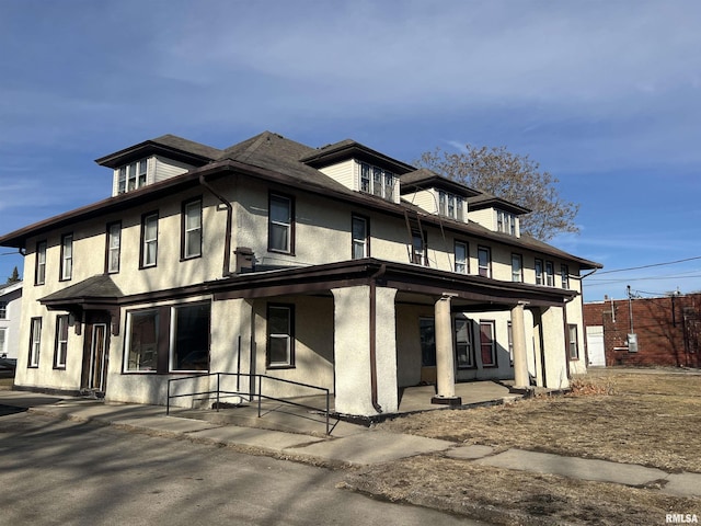 view of front of house with a porch and stucco siding