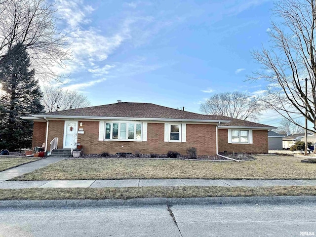 ranch-style home with entry steps and brick siding