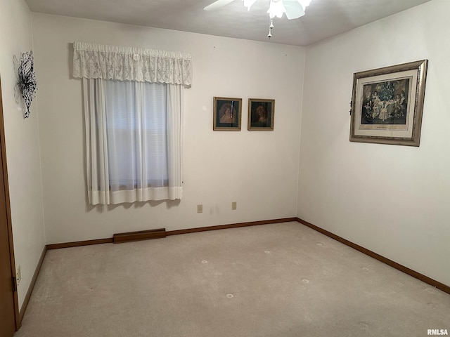 empty room featuring carpet floors, ceiling fan, and baseboards