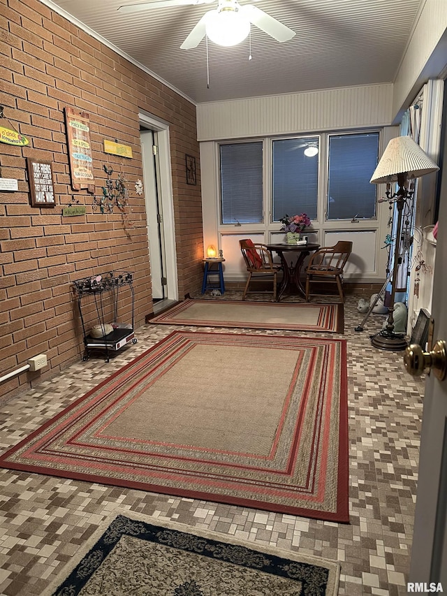 interior space featuring brick wall and ceiling fan