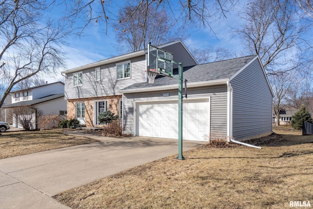 colonial house featuring a garage, brick siding, driveway, and a front lawn