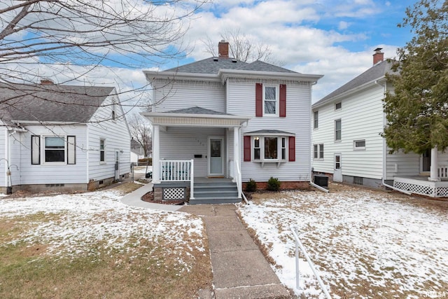 american foursquare style home with covered porch, roof with shingles, and a chimney