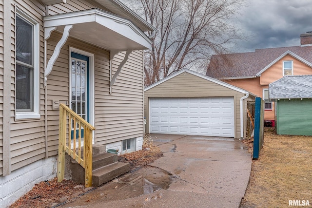 entrance to property featuring a detached garage