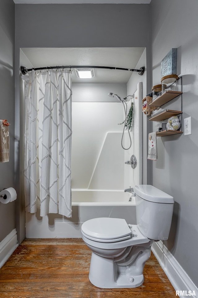 bathroom with wood finished floors, toilet, and shower / bathtub combination with curtain