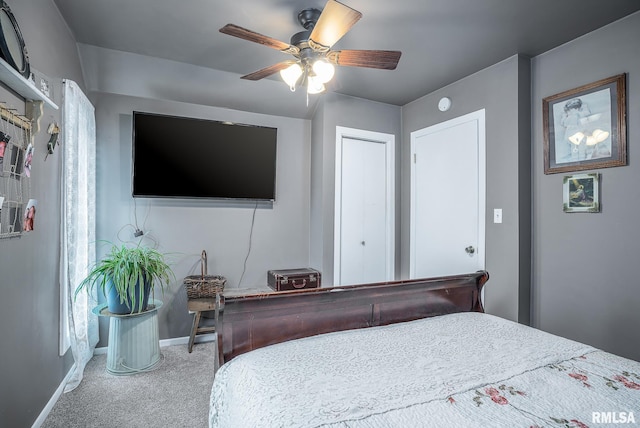 carpeted bedroom featuring baseboards and a ceiling fan