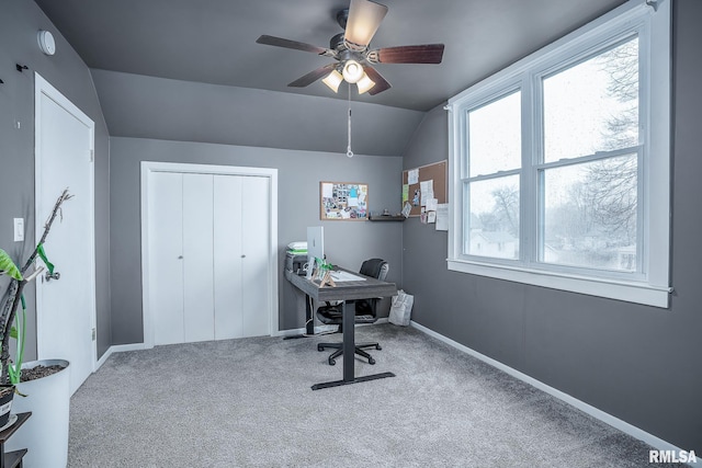 office space featuring lofted ceiling, carpet, a ceiling fan, and baseboards