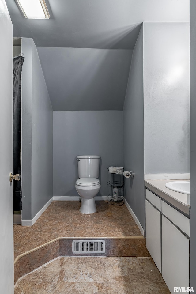 full bath with lofted ceiling, toilet, vanity, baseboards, and visible vents