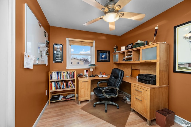 office featuring light wood-style floors, ceiling fan, and baseboards