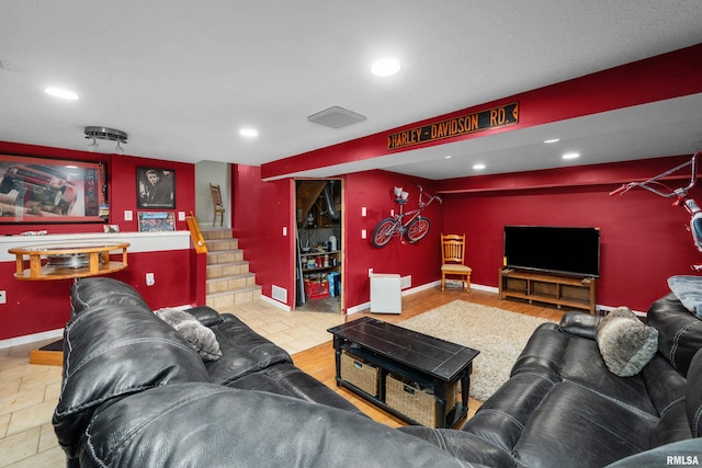 living room featuring stairs, baseboards, visible vents, and recessed lighting