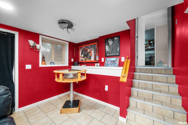 interior space featuring baseboards and tile patterned floors