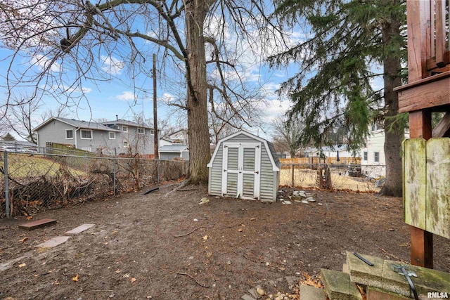 view of yard with an outbuilding, a fenced backyard, and a shed