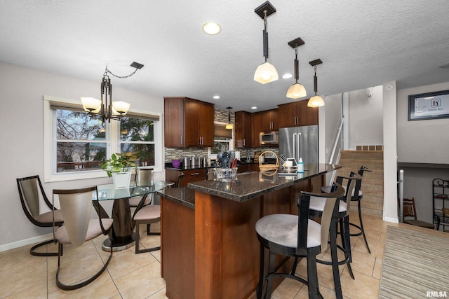 kitchen with high quality fridge, white microwave, a breakfast bar, visible vents, and tasteful backsplash