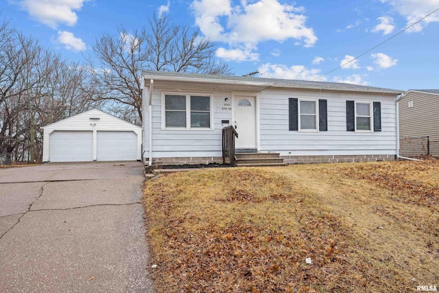 view of front of home with an outbuilding, entry steps, a detached garage, and a front lawn