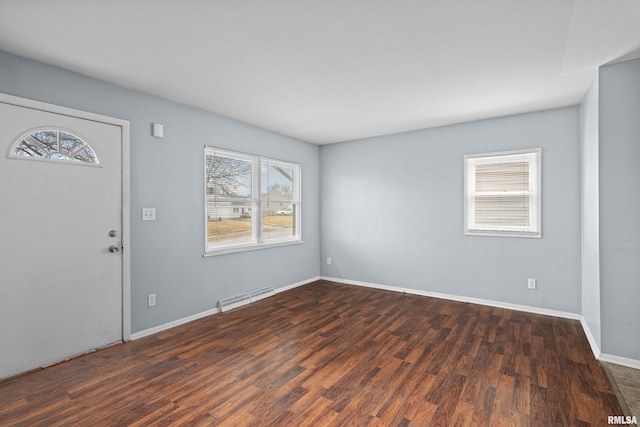 entryway featuring wood finished floors, visible vents, and baseboards