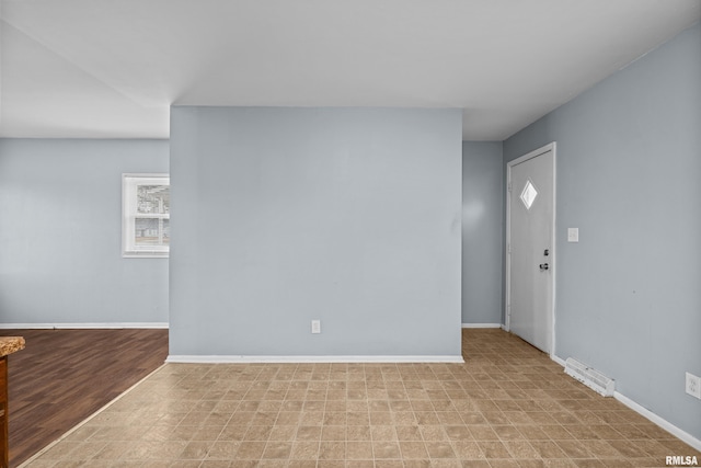 entrance foyer featuring light floors, visible vents, and baseboards