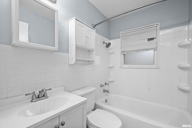 bathroom with  shower combination, toilet, tile walls, and vanity