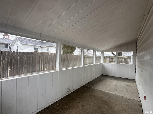 unfurnished sunroom featuring lofted ceiling