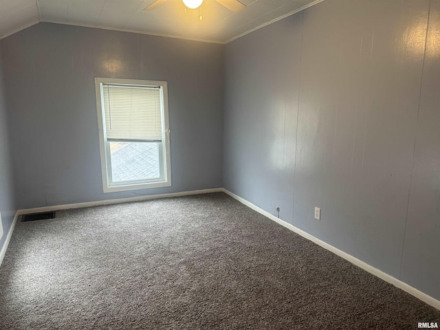 carpeted empty room with visible vents, baseboards, lofted ceiling, ceiling fan, and ornamental molding