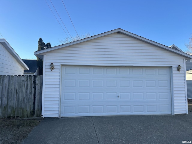 detached garage featuring fence