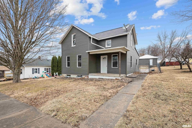 traditional-style house with a front yard and covered porch