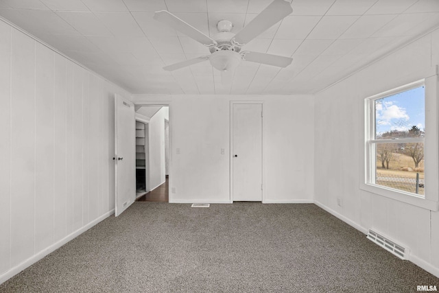 unfurnished bedroom featuring carpet floors, visible vents, and a ceiling fan