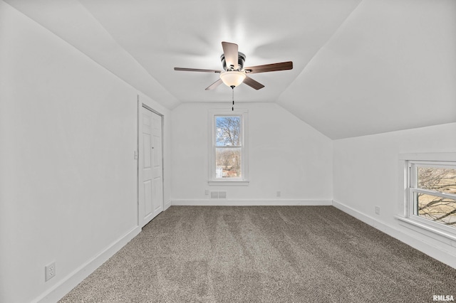 bonus room featuring carpet, visible vents, vaulted ceiling, and baseboards