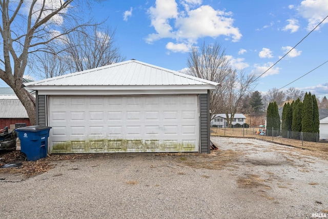 detached garage featuring fence