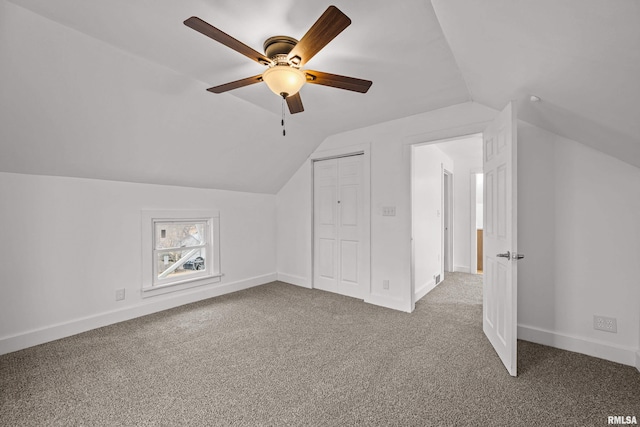 bonus room with lofted ceiling, carpet, a ceiling fan, and baseboards