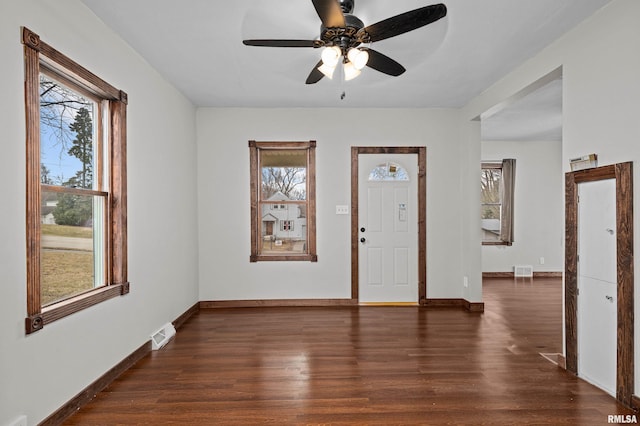 entryway with a ceiling fan, dark wood-style flooring, visible vents, and baseboards