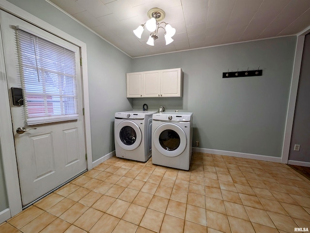 clothes washing area featuring washer and dryer, cabinet space, crown molding, and baseboards