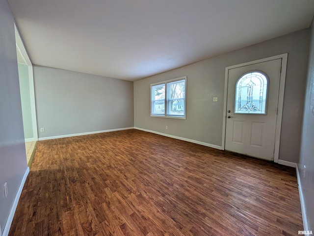 entryway with baseboards and wood finished floors