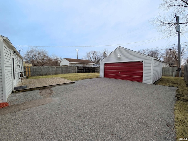 detached garage featuring fence