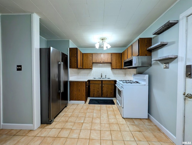 kitchen featuring open shelves, tasteful backsplash, white gas range, stainless steel microwave, and freestanding refrigerator