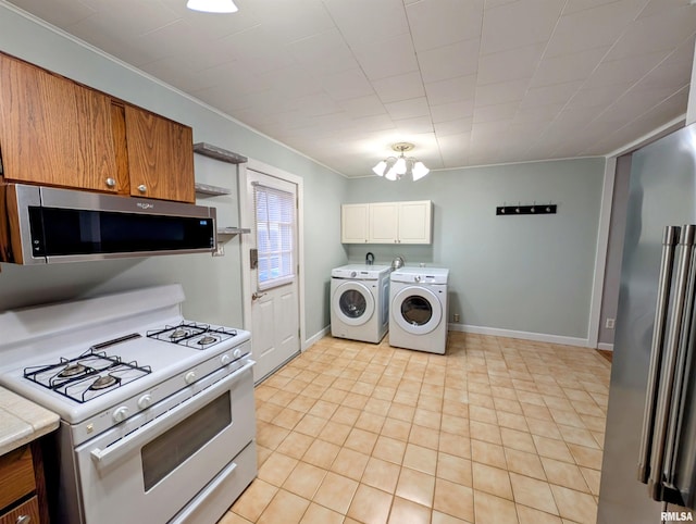 kitchen featuring baseboards, stainless steel appliances, open shelves, and washer and dryer