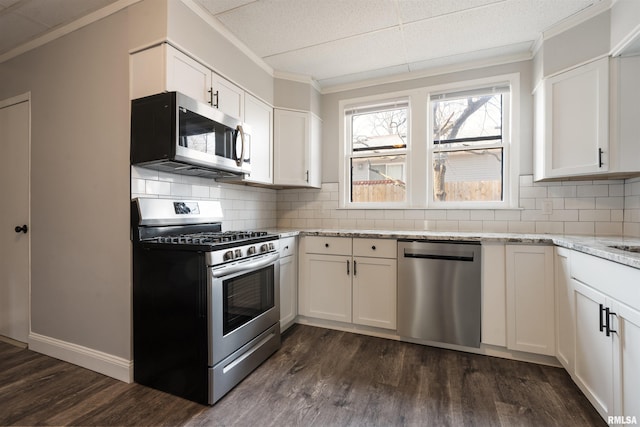 kitchen with stainless steel appliances, dark wood finished floors, backsplash, and light stone counters