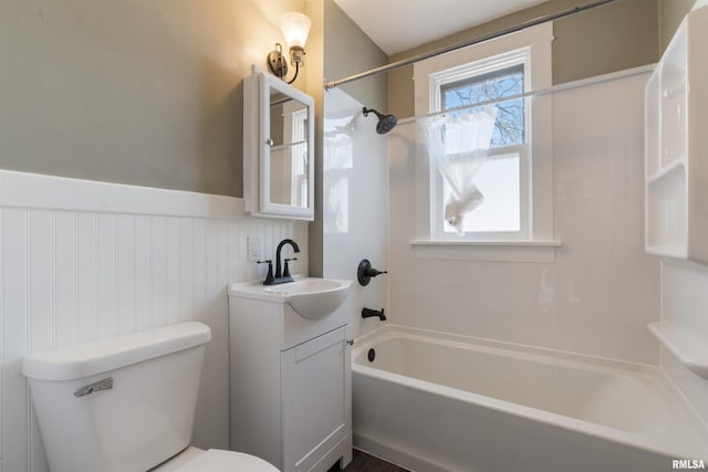 full bath with toilet, shower / tub combination, vanity, and wainscoting