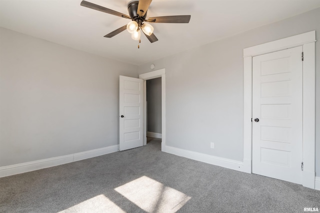 unfurnished bedroom featuring a ceiling fan, carpet flooring, and baseboards