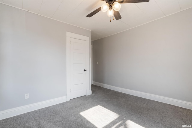 empty room with carpet floors, ceiling fan, and baseboards