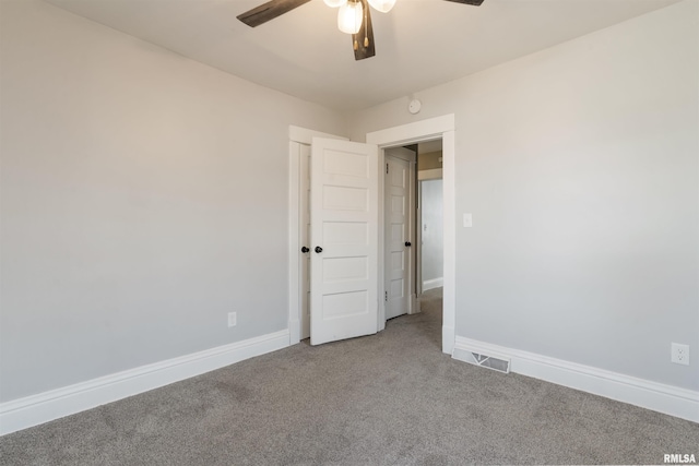 spare room featuring a ceiling fan, baseboards, visible vents, and carpet flooring