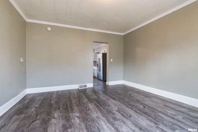 unfurnished room featuring baseboards, crown molding, visible vents, and dark wood-style flooring