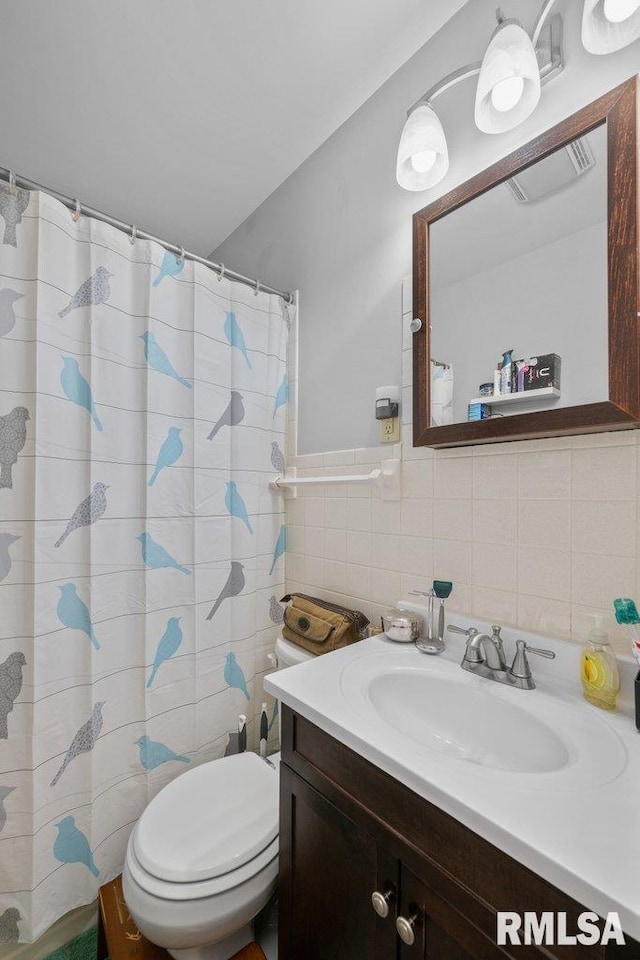 full bathroom with toilet, visible vents, vanity, and tile walls