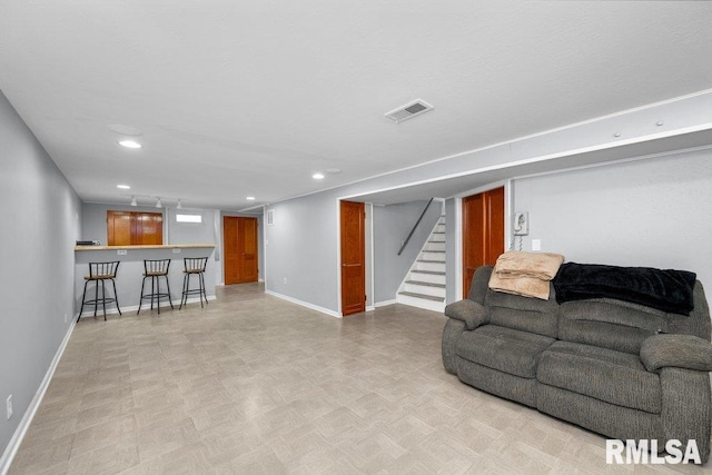 living room with baseboards, visible vents, stairs, a bar, and recessed lighting